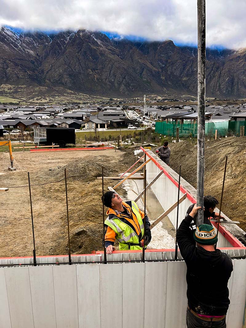 Installed AFS Logicwall for the intertenancy walls with boom pump and concrete truck behind the wall.