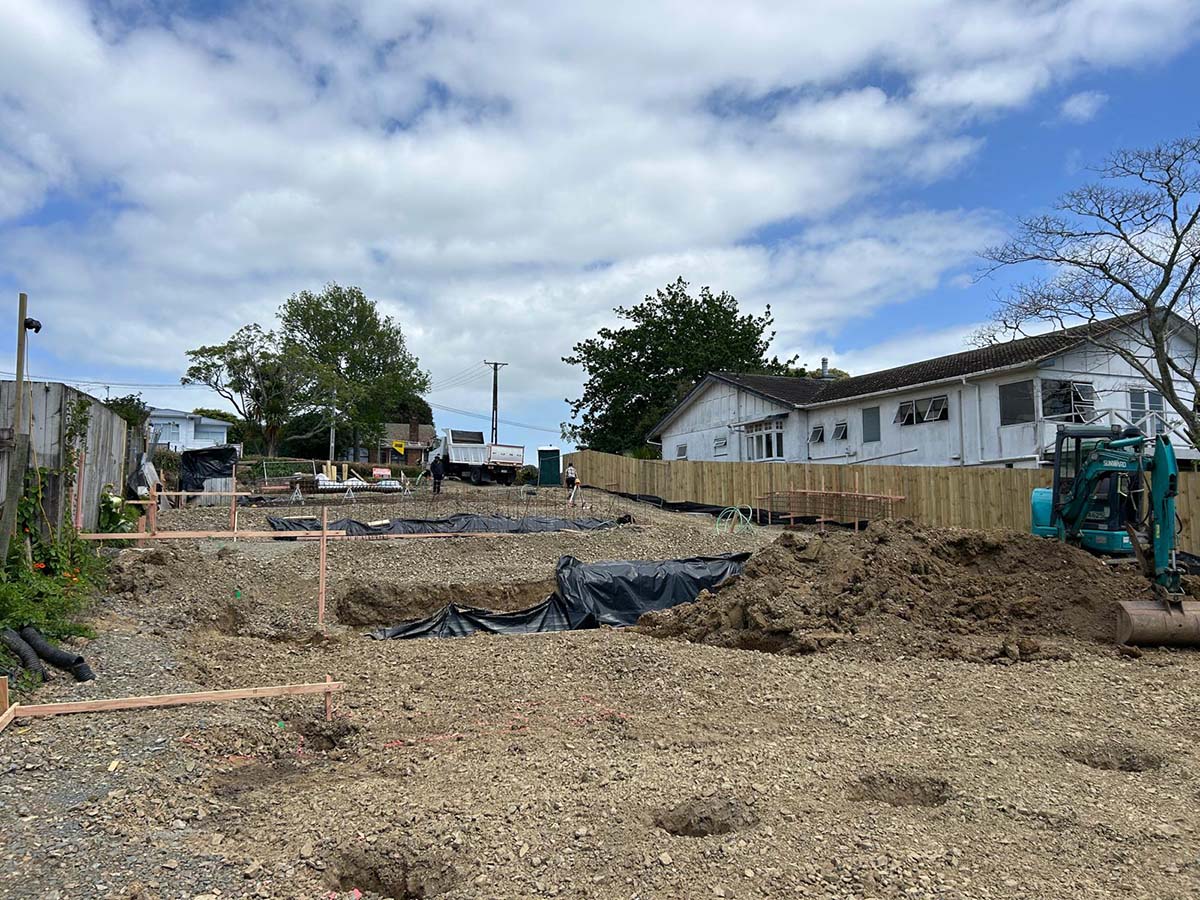 Installed AFS Logicwall for the intertenancy walls with boom pump and concrete truck behind the wall.